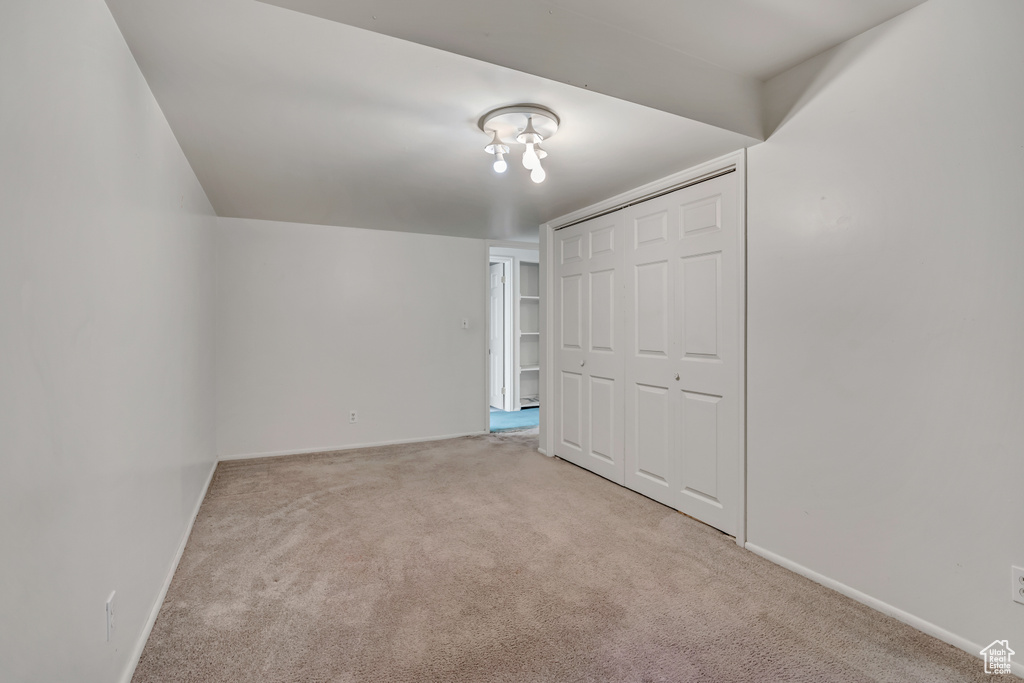 Unfurnished bedroom featuring carpet floors and a closet