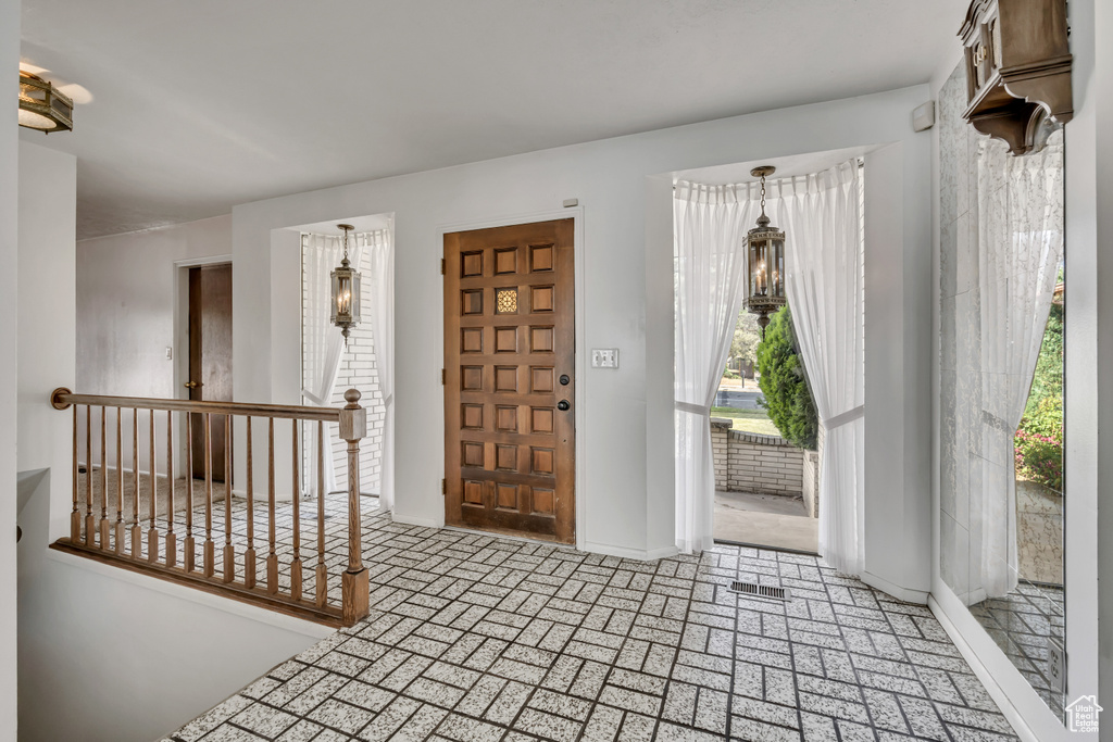 Entryway with baseboards and brick patterned floors