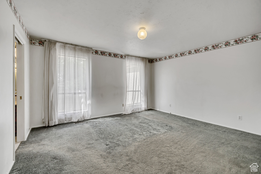 Unfurnished room with carpet floors and baseboards