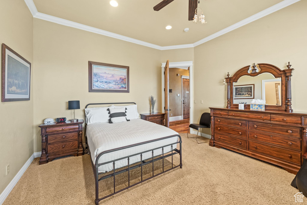 Bedroom with crown molding, light colored carpet, recessed lighting, and ceiling fan