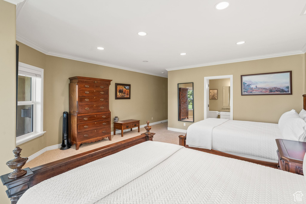Bedroom featuring light colored carpet, ornamental molding, recessed lighting, and ensuite bathroom