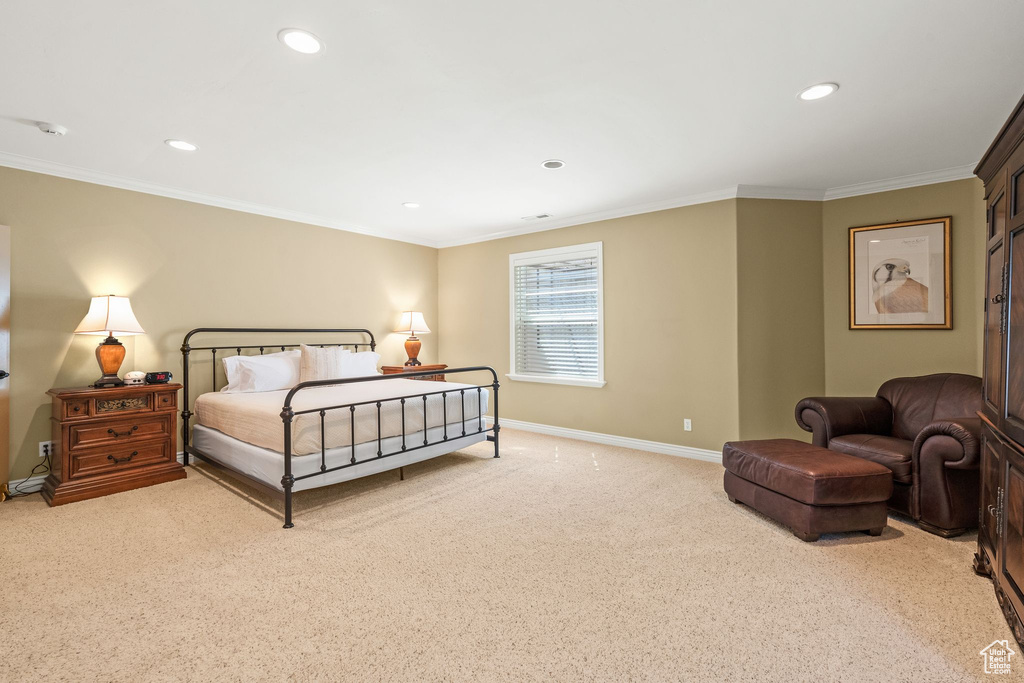 Bedroom with light carpet, recessed lighting, and ornamental molding