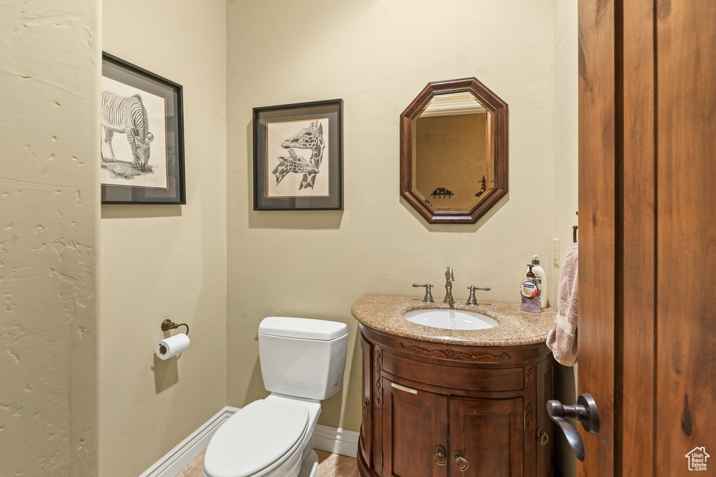 Half bathroom featuring toilet and vanity