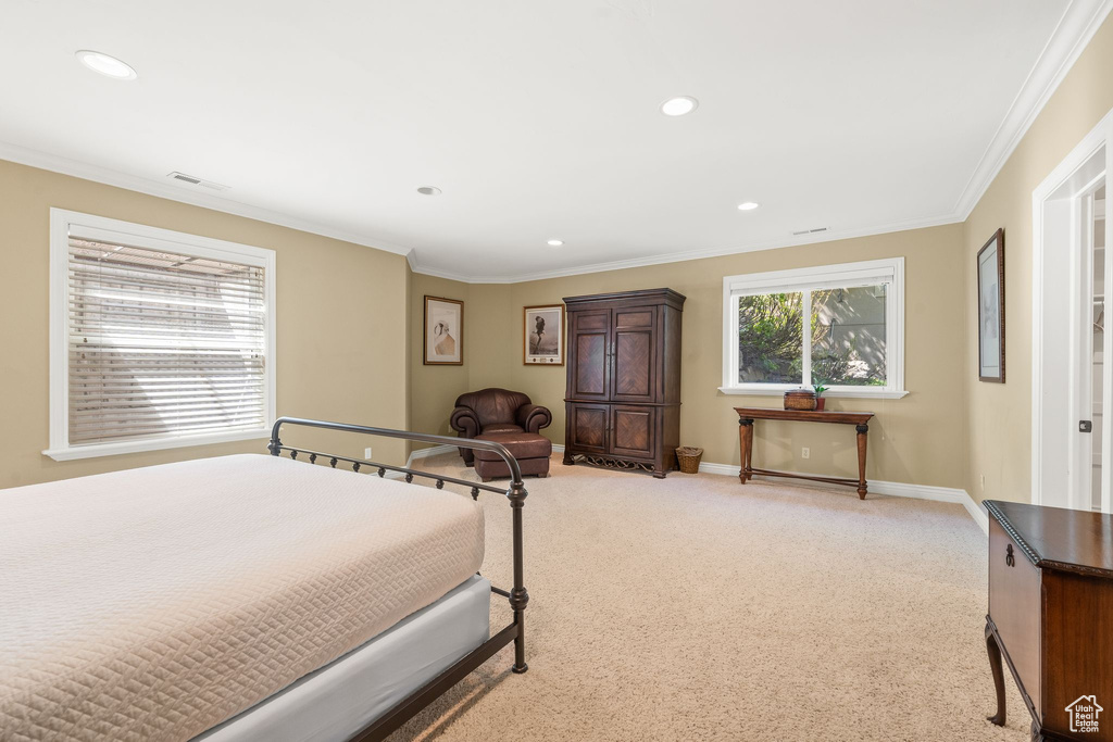 Bedroom with ornamental molding, light carpet, and recessed lighting