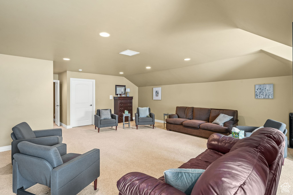 Living room featuring light carpet, recessed lighting, and lofted ceiling
