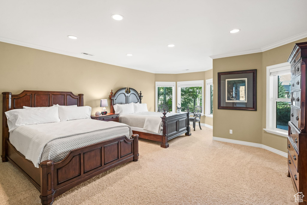 Bedroom with light carpet, recessed lighting, and ornamental molding