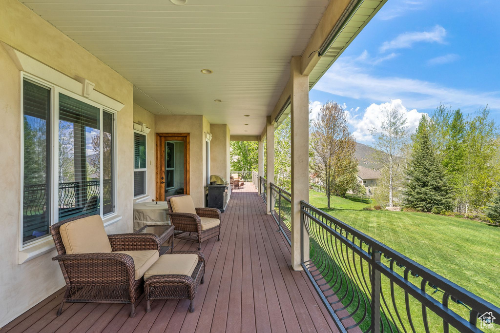 Wooden deck featuring a lawn
