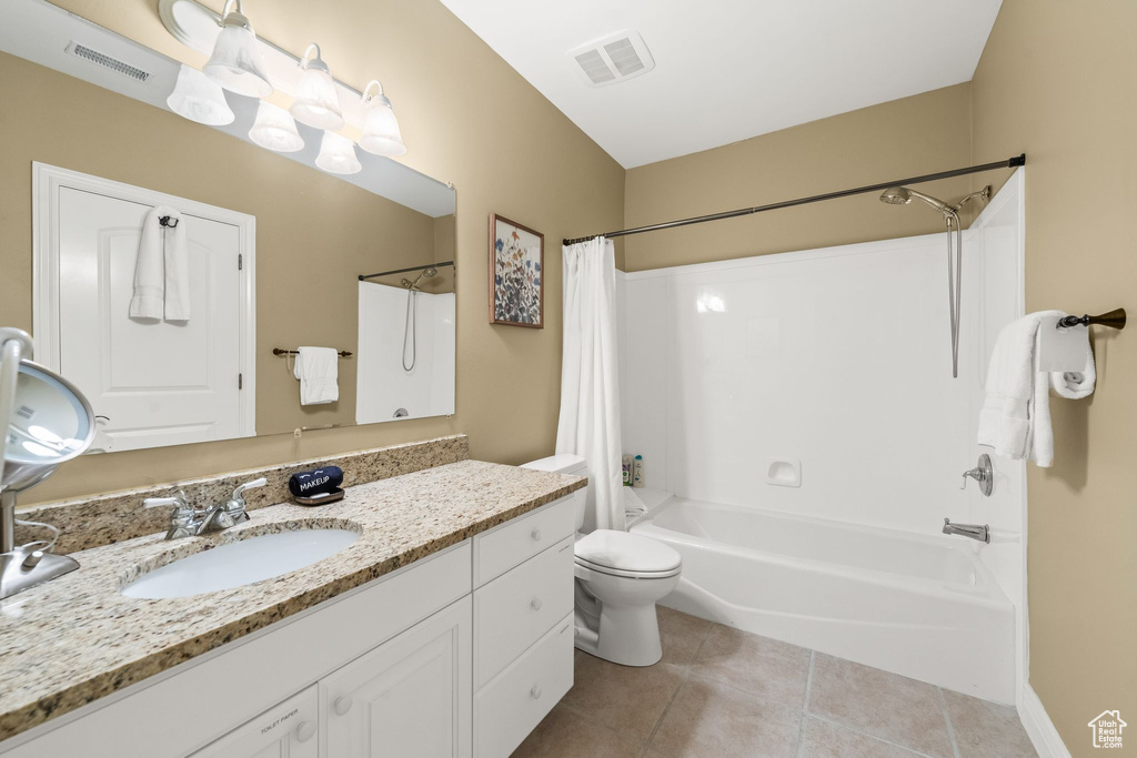 Full bathroom with shower / bath combination with curtain, vanity, and tile patterned flooring