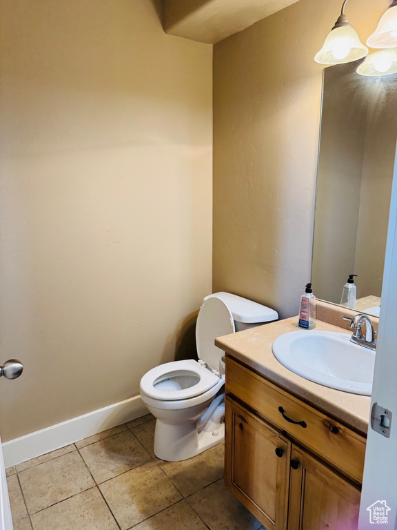 Half bath with vanity and tile patterned floors