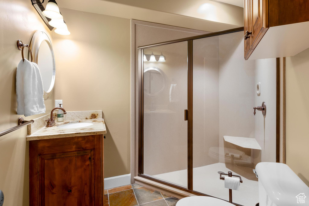 Full bathroom with vanity and a stall shower
