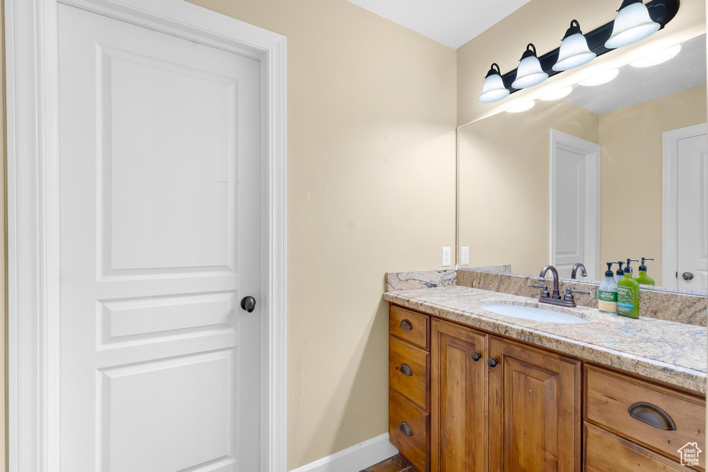Bathroom with vanity and baseboards