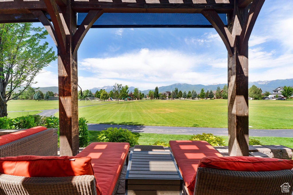 View of patio featuring a mountain view and view of golf course