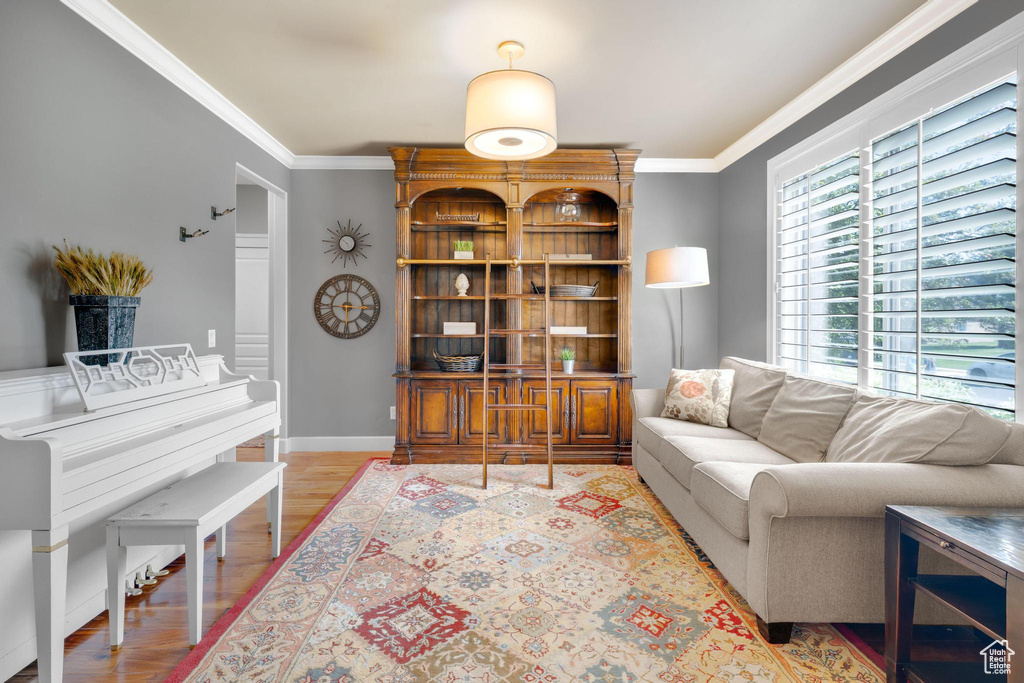 Living room featuring ornamental molding and wood finished floors