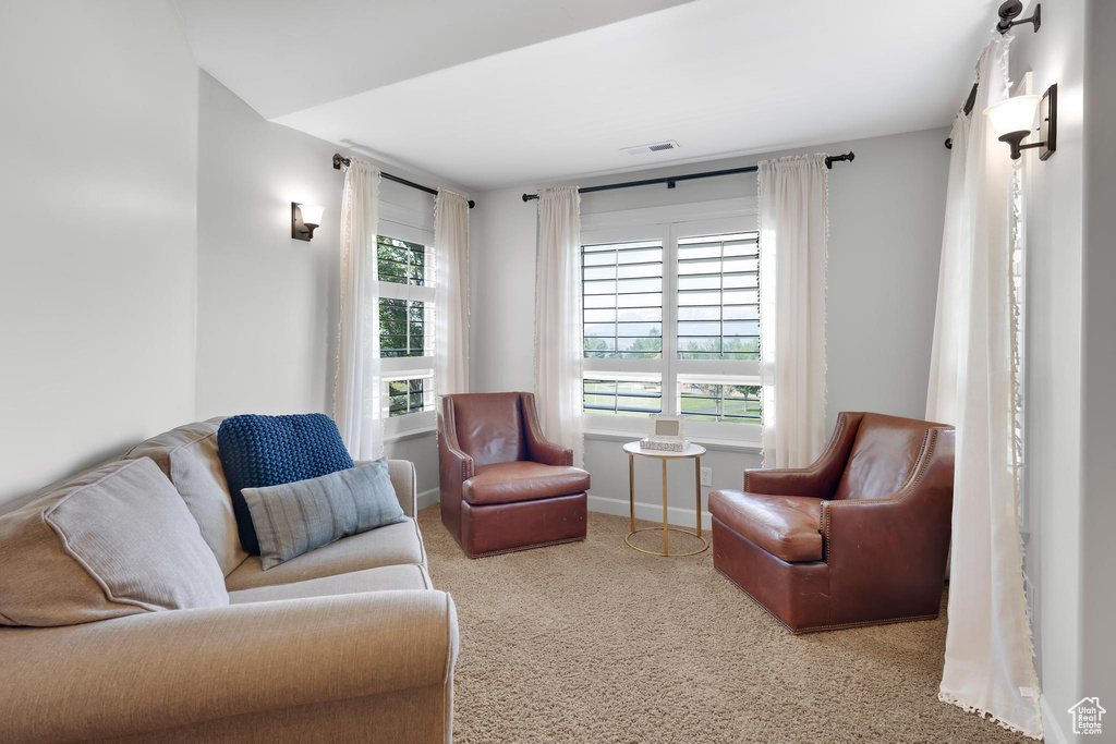 Sitting room featuring carpet flooring