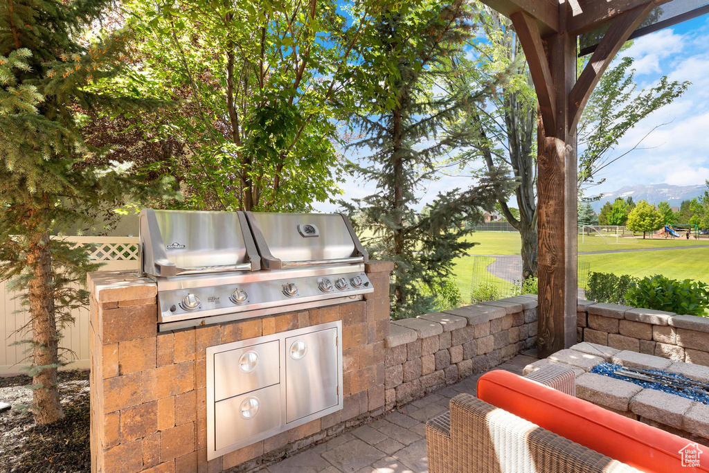 View of patio featuring exterior kitchen and a mountain view