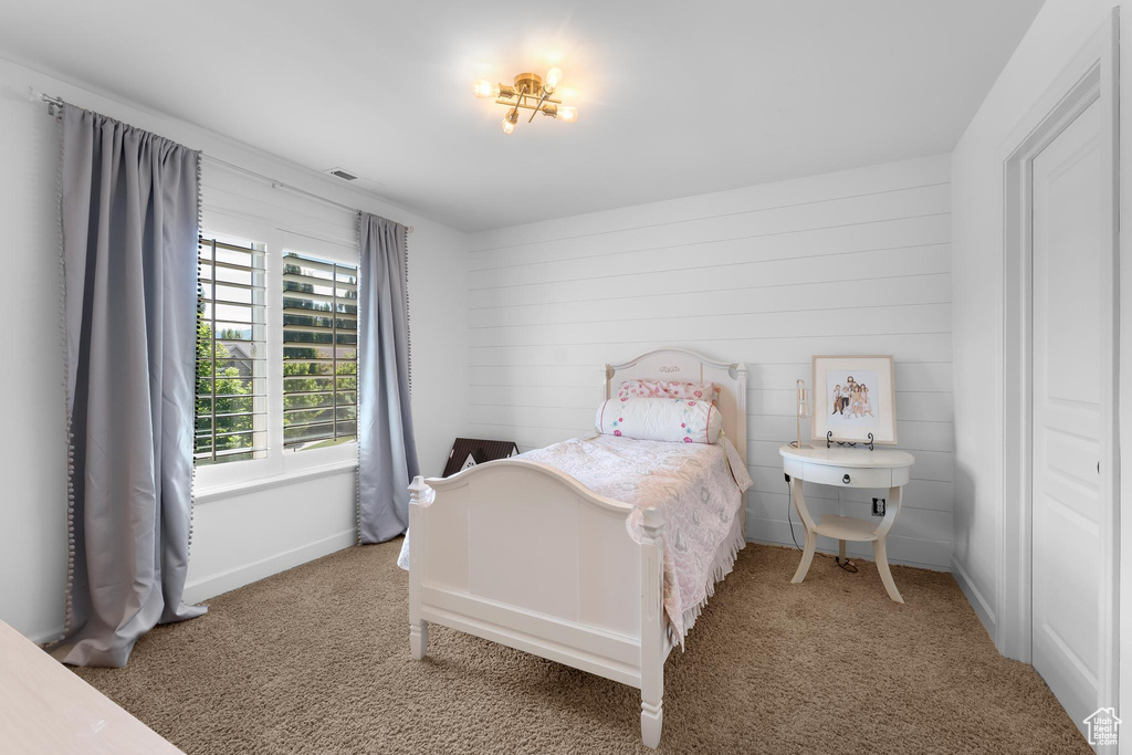 Carpeted bedroom with baseboards