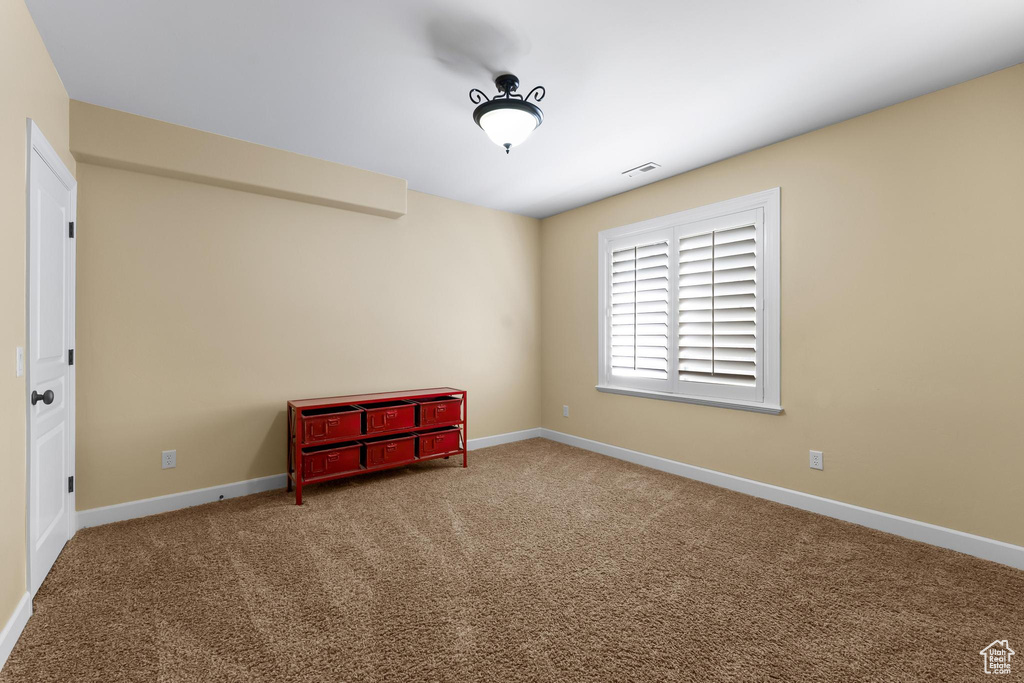 Spare room with carpet and baseboards