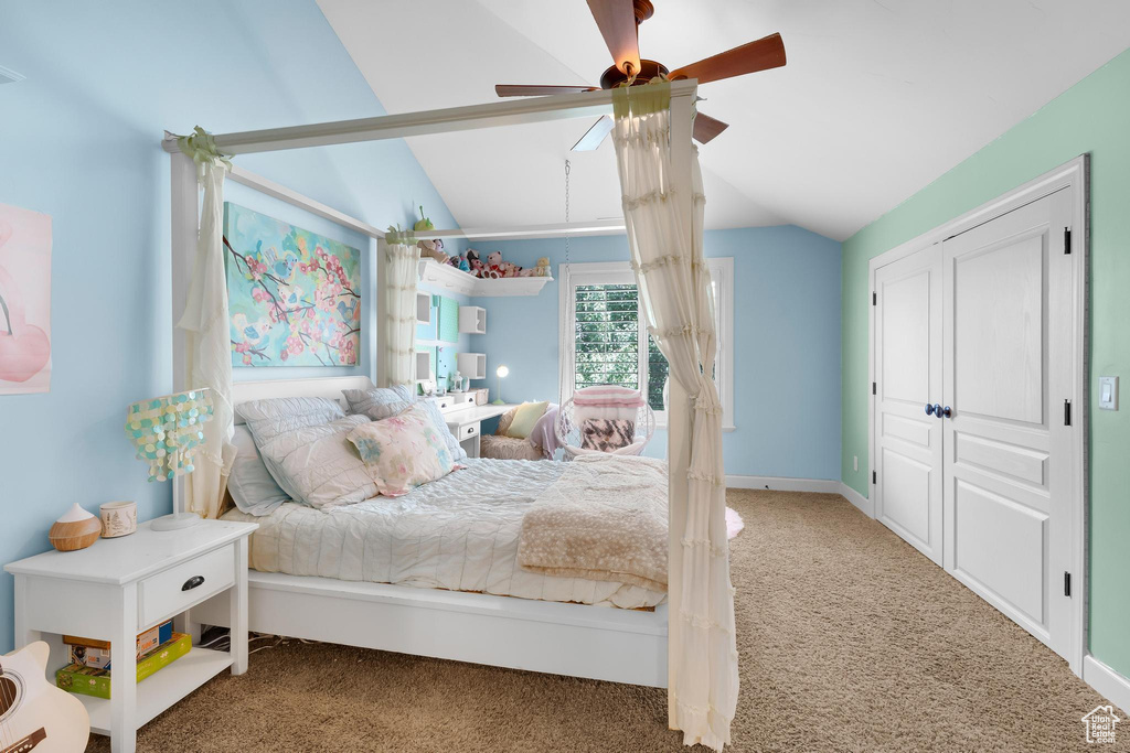 Bedroom featuring carpet flooring, lofted ceiling, and ceiling fan