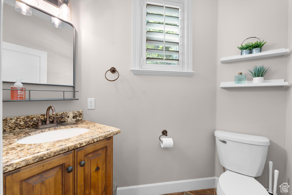 Half bathroom featuring toilet and vanity