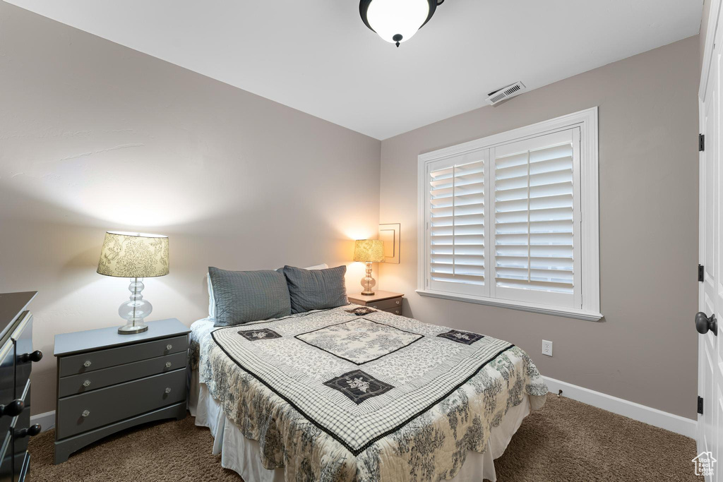 Carpeted bedroom with baseboards