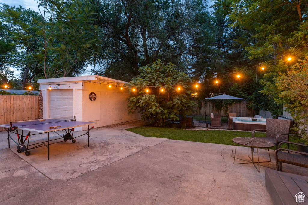 View of patio featuring driveway, a hot tub, and outdoor dining area