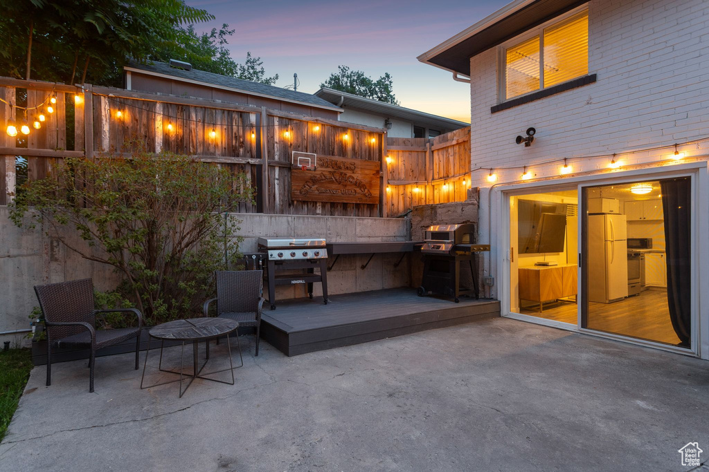 View of patio / terrace with area for grilling and a wooden deck