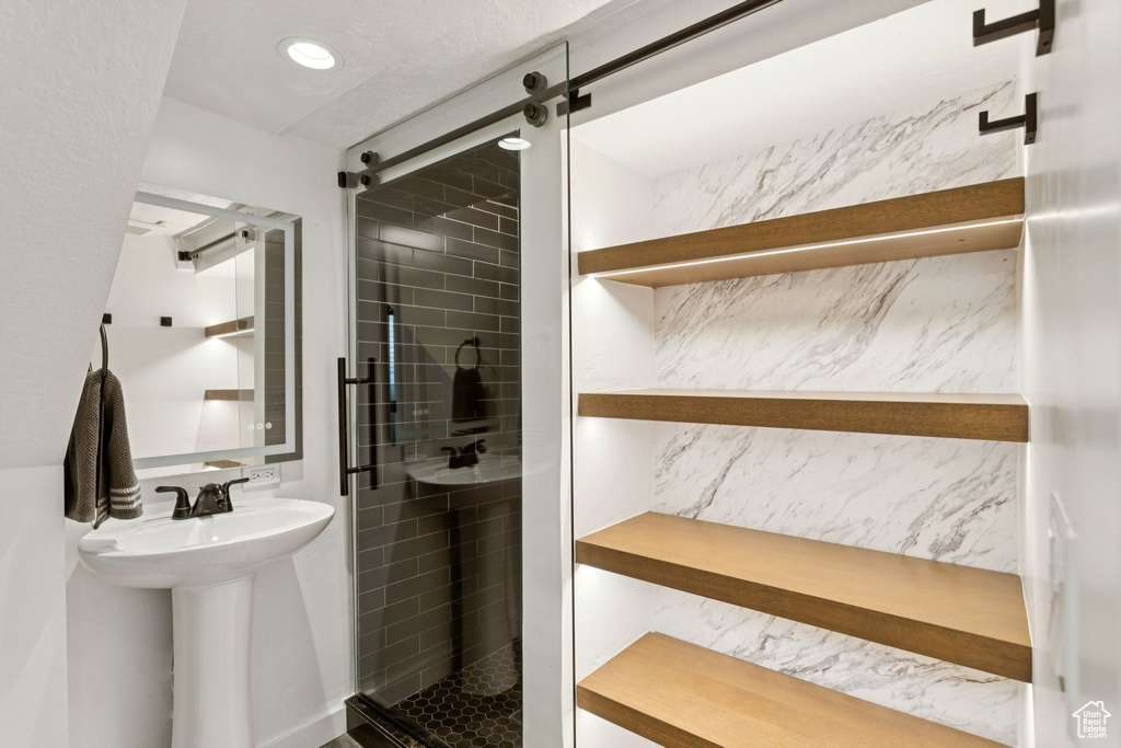 Full bath featuring a shower stall and a sink
