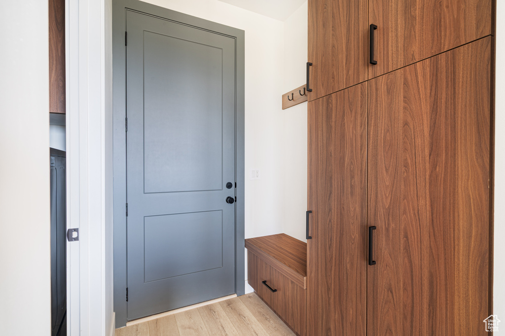 Doorway with light wood finished floors