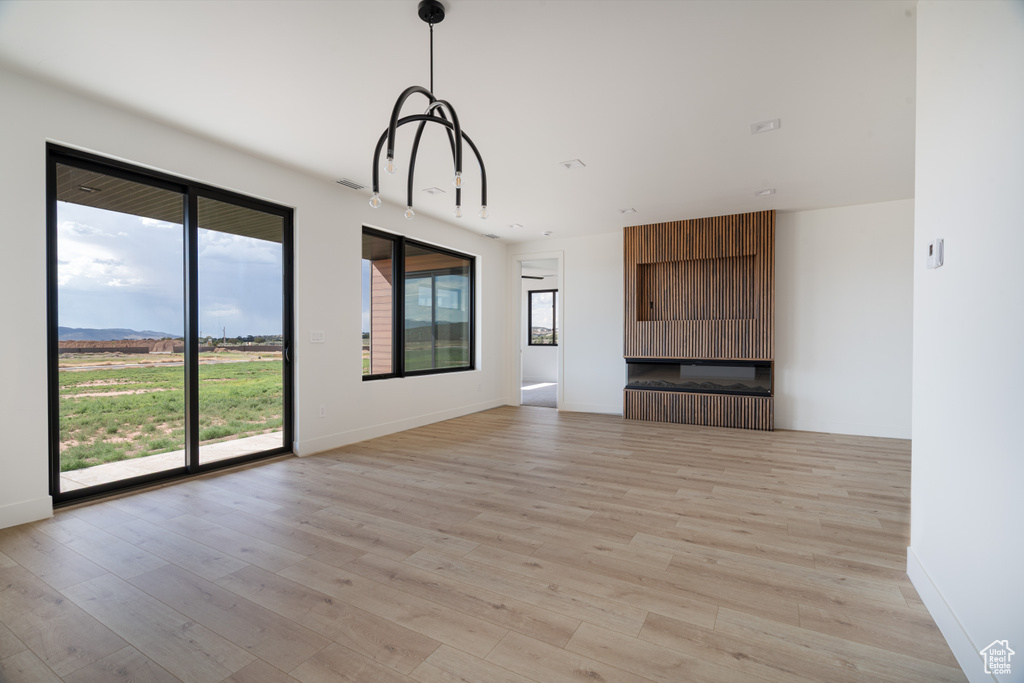 Unfurnished living room with light wood-style flooring