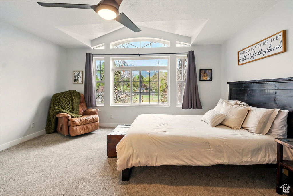 Bedroom with carpet flooring, vaulted ceiling, and ceiling fan