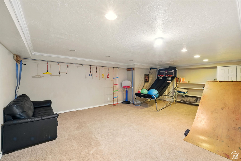 Sitting room with carpet, recessed lighting, ornamental molding, and a textured ceiling