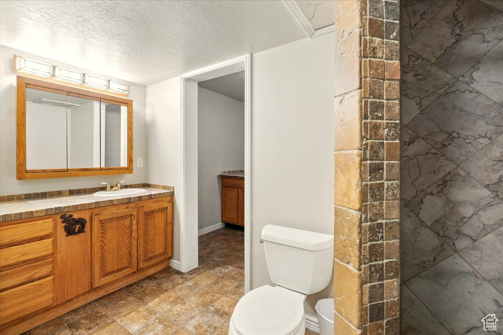 Bathroom featuring vanity and a textured ceiling