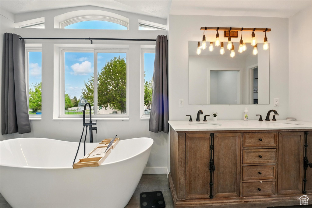 Full bathroom with double vanity and a soaking tub