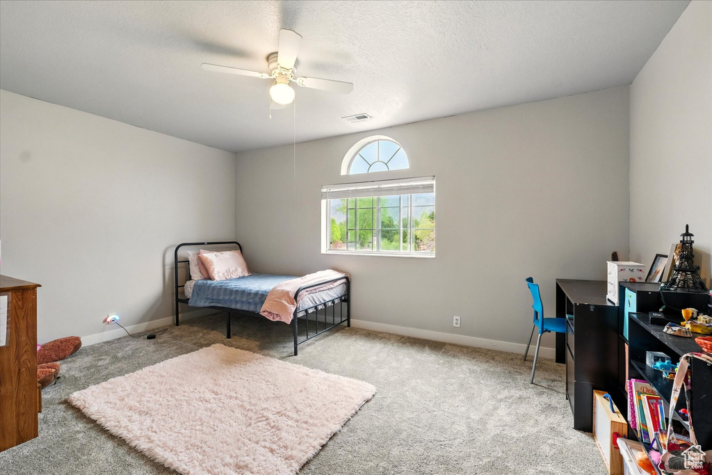 Bedroom with carpet floors and a ceiling fan