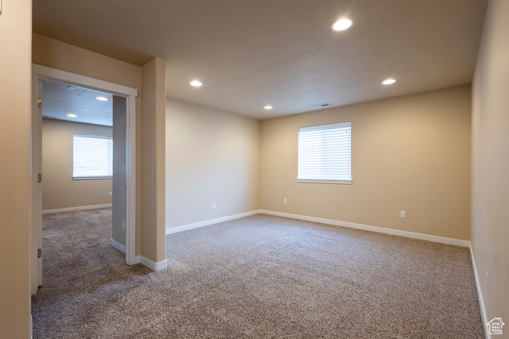 Spare room featuring carpet and recessed lighting