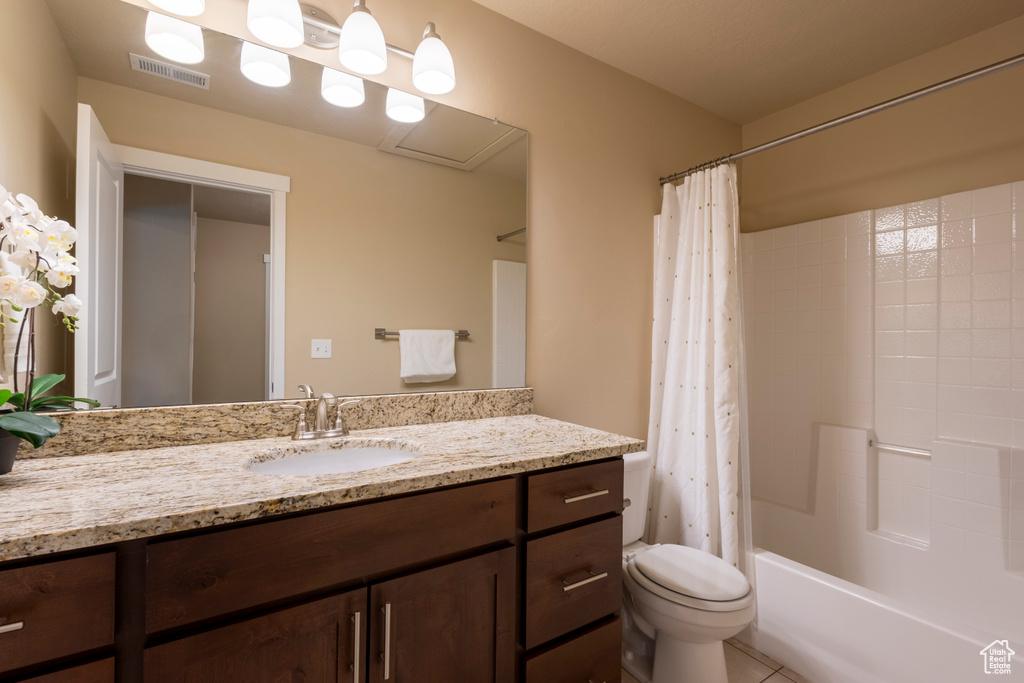 Bathroom with vanity, shower / bathtub combination with curtain, and tile patterned floors