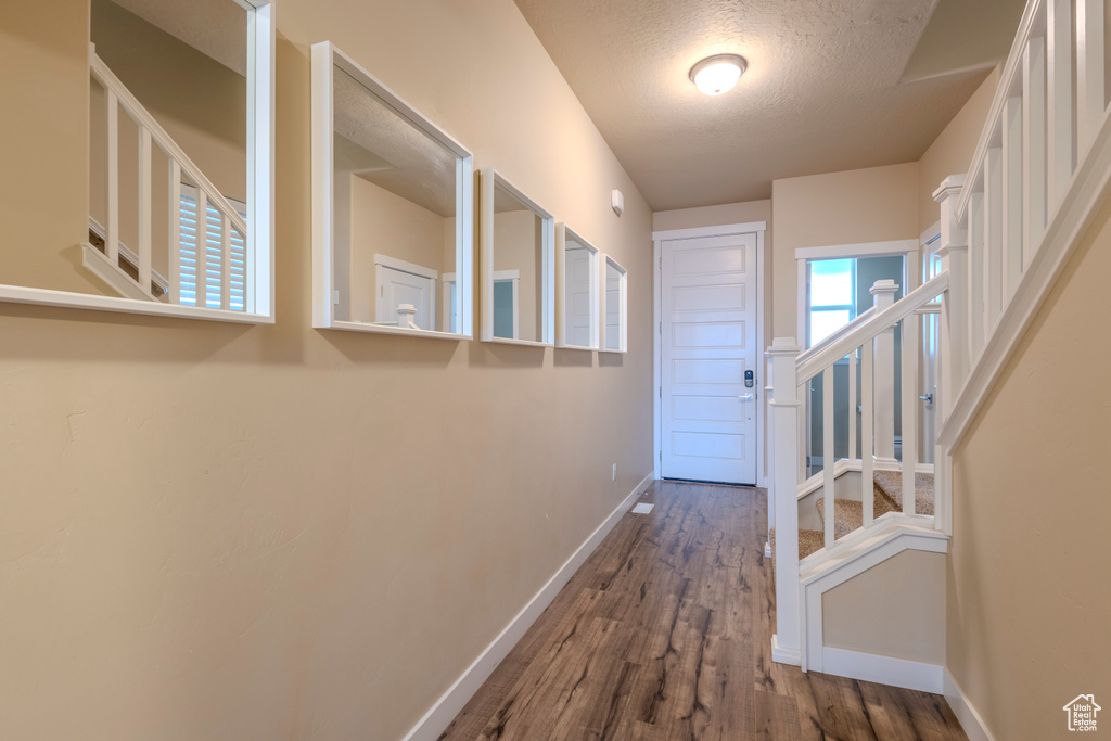 Entryway with wood finished floors and a textured ceiling