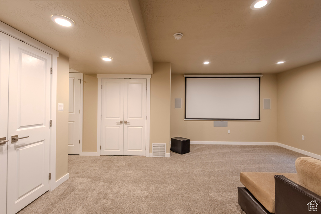 Carpeted home theater room featuring recessed lighting