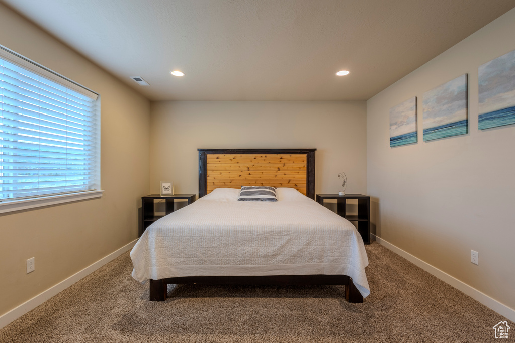 Carpeted bedroom with recessed lighting