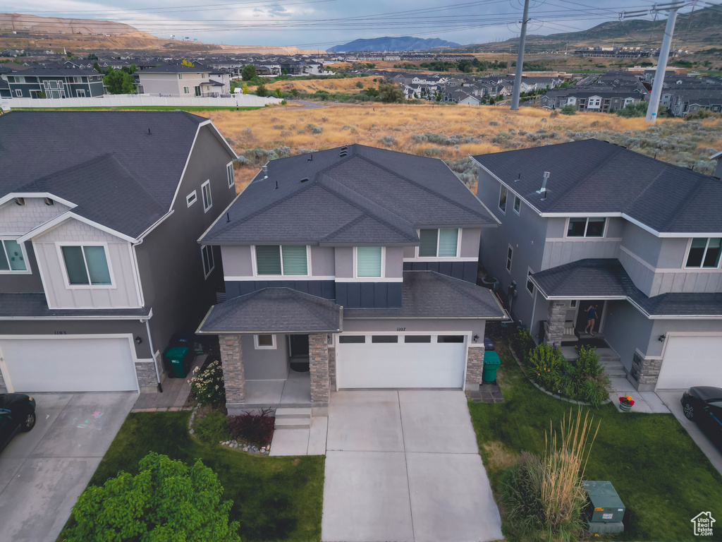 Aerial perspective of suburban area featuring a mountain backdrop