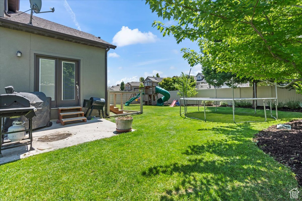 View of yard featuring a playground, entry steps, and a patio