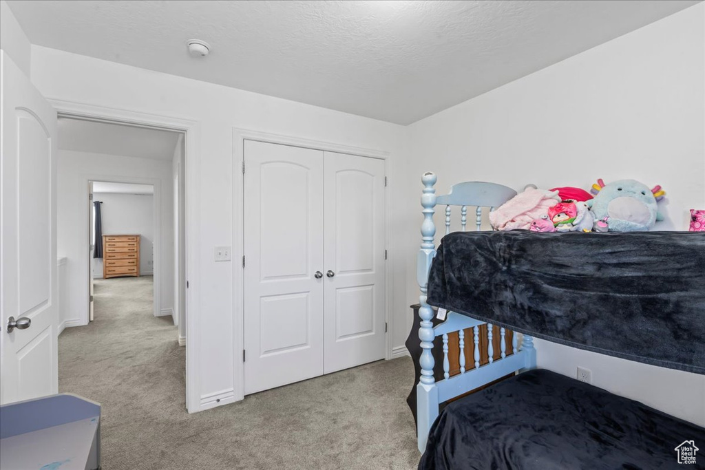 Bedroom featuring carpet floors and a closet