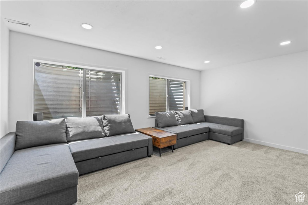 Carpeted living area featuring recessed lighting