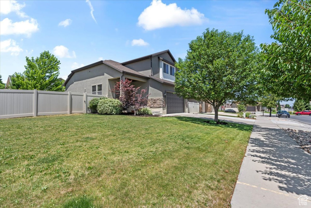 View of side of home featuring stucco siding and a garage