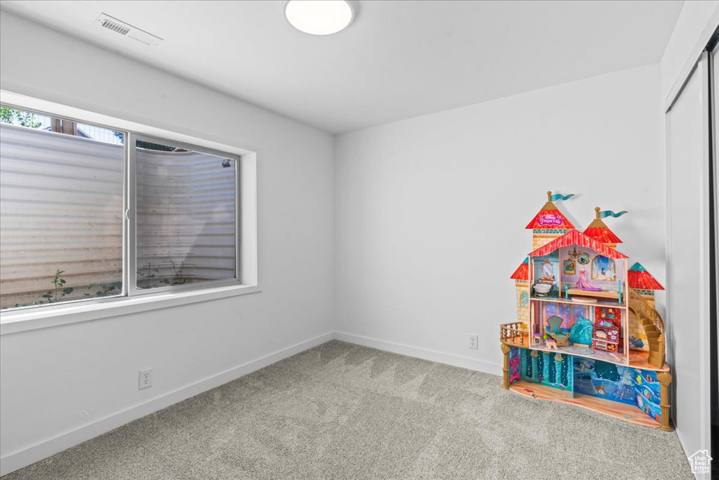 Game room featuring carpet and baseboards