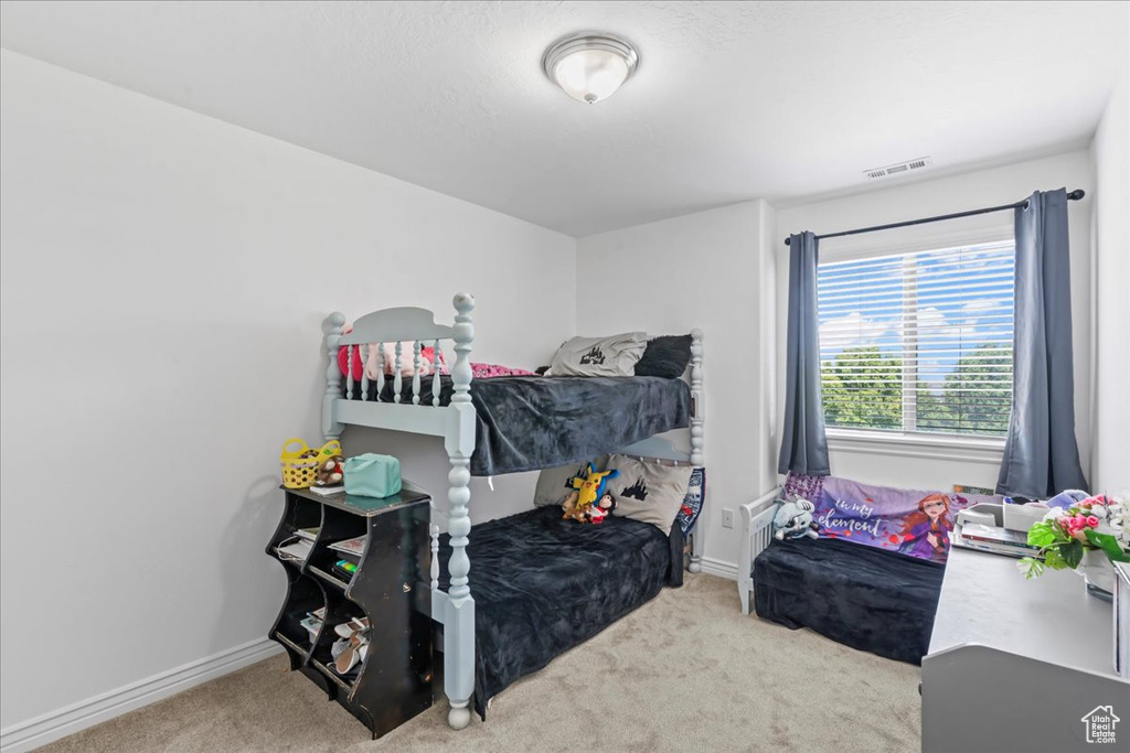 Carpeted bedroom featuring baseboards