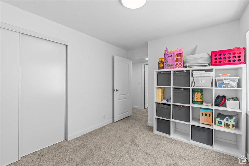 Carpeted bedroom featuring a closet and baseboards