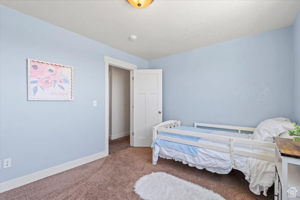 Carpeted bedroom with baseboards