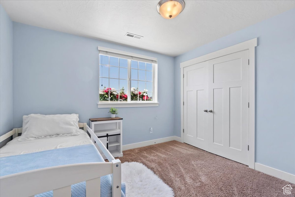 Bedroom featuring carpet flooring and baseboards