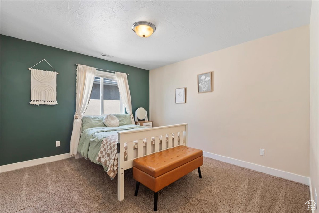 Bedroom featuring carpet flooring and baseboards